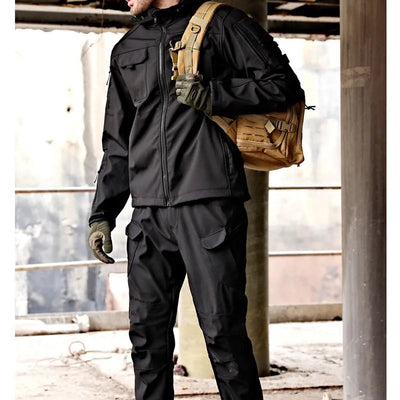 posed view of black mens outdoor jacket and pants set