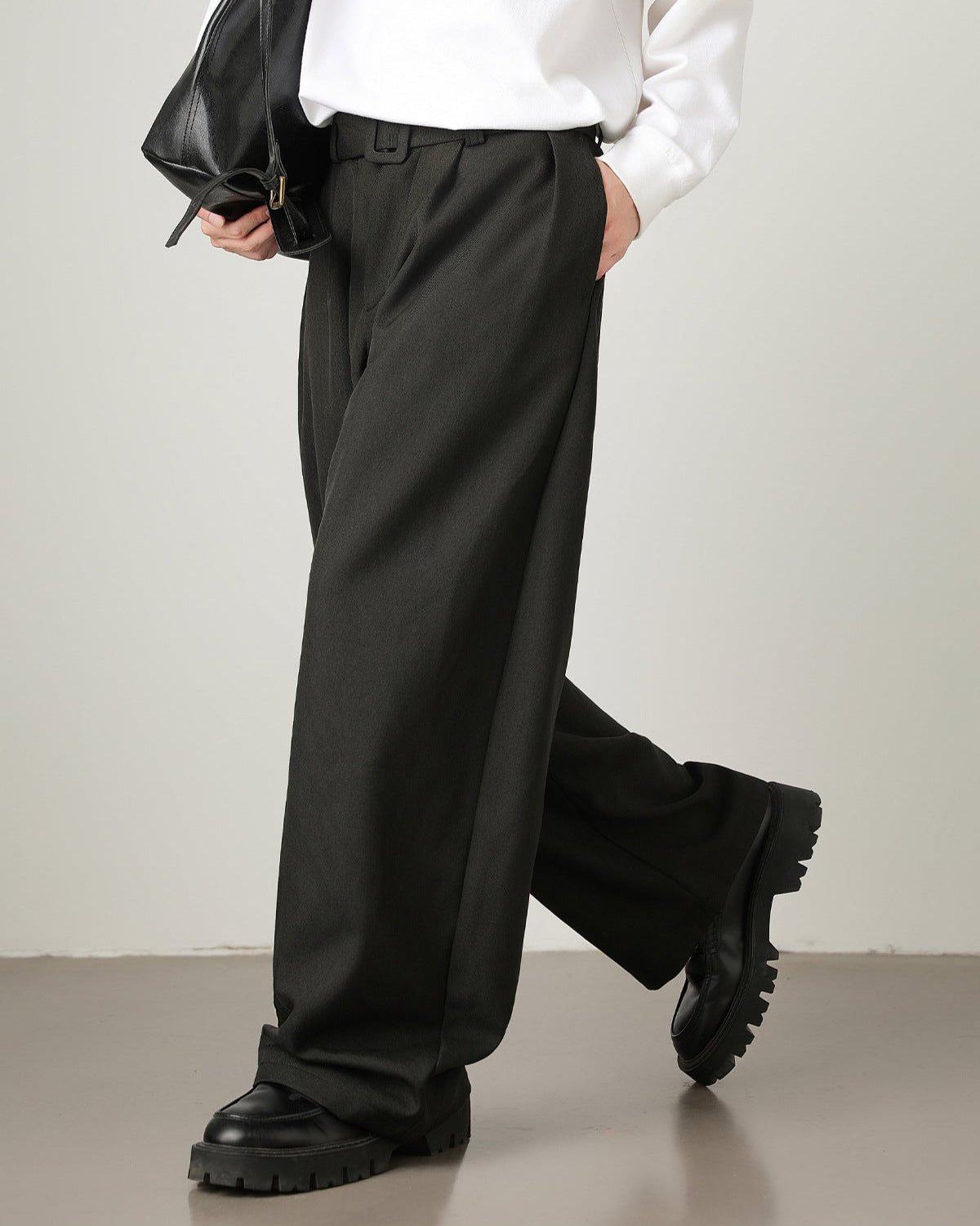 side view of black men’s wool blend wide-leg trousers