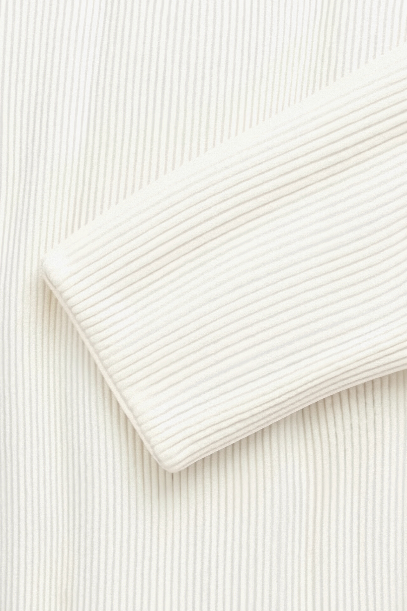 sleeve detail of solid knitted crew neck cardigan